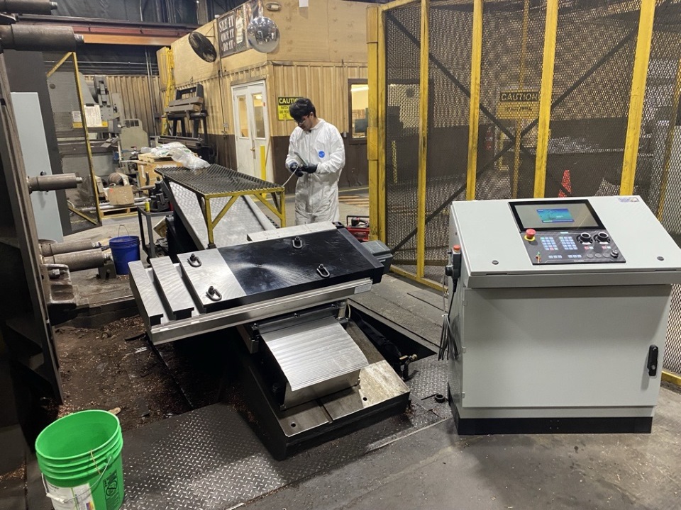 Technician at a retrofitted machine tool on a customer site