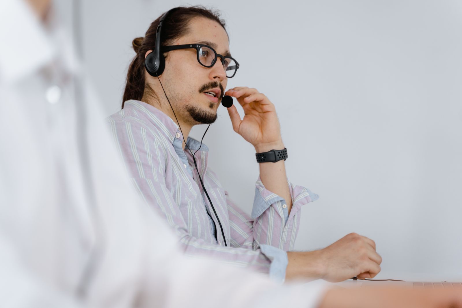 Support engineer on a headset walking a customer through a fault