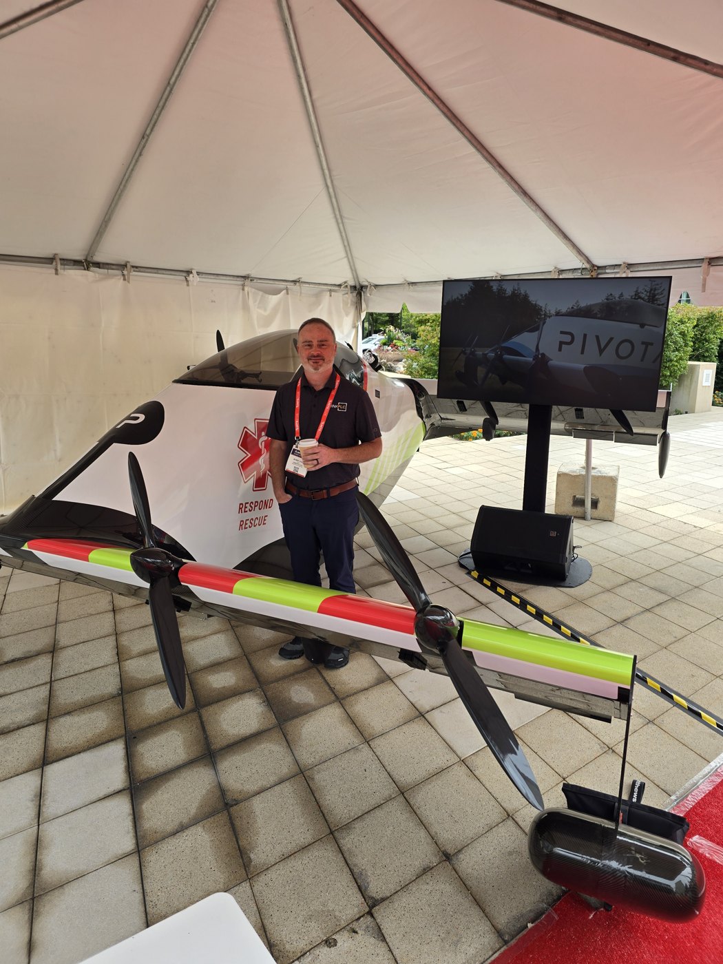 Bobby Cole at IMTS 2026 in front of a Pivotal electric aircraft